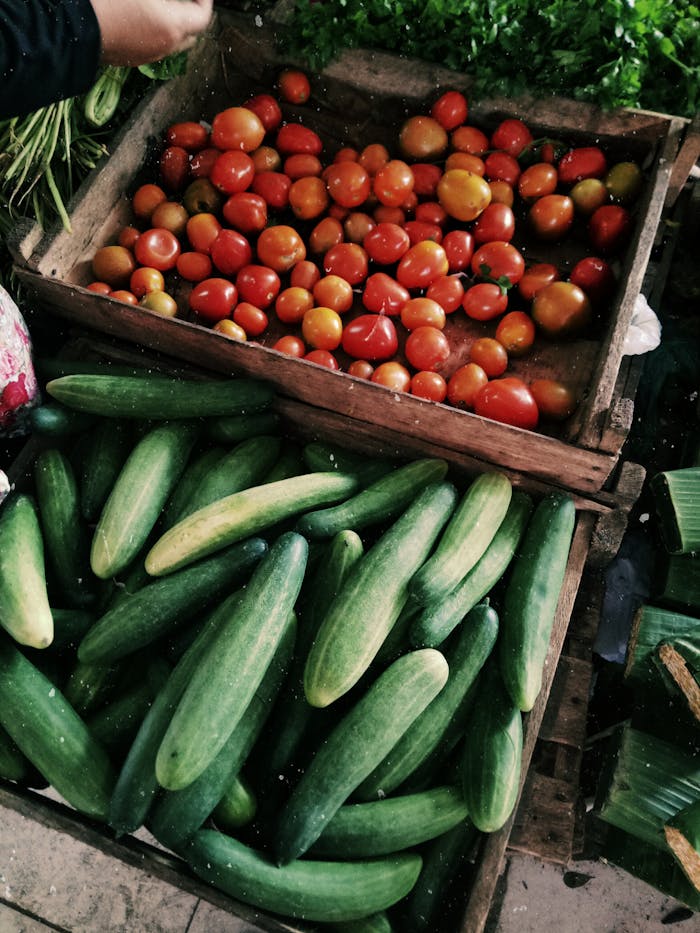 our-story Vibrant tomatoes and cucumbers on display at a local farmers market.